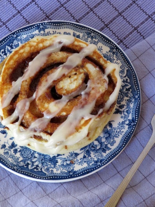 Cinnamon Pancakes on a blue and white toile plate with a purple check placemat.