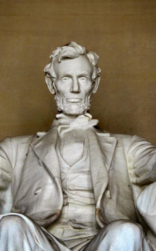 Close-up of a statue of Abraham Lincoln sitting in a chair. 