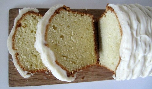 Vanilla Cream Cheese Cake with Vanilla Bean Frosting sliced on a cutting board. 