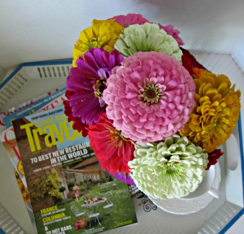 blue and white tole tray with a vase of colorful flowers and a pile of magazines, summer fun list. 