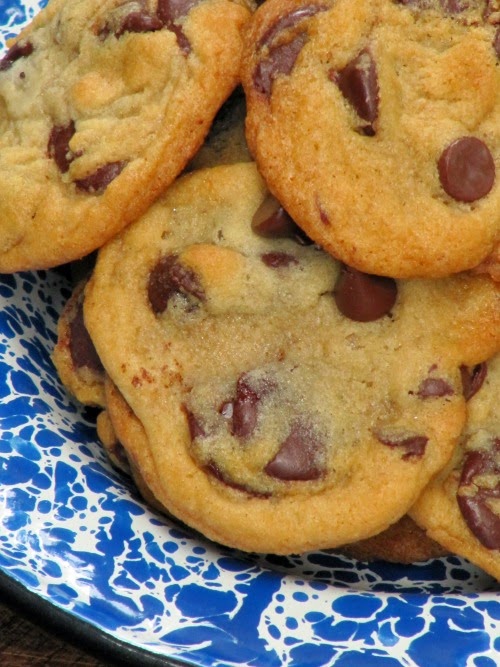 Chocolate chip cookies in a blue spatterware bowl. 