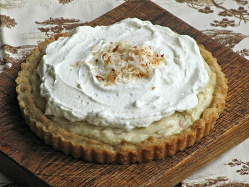 Coconut cream pie on a cutting board. 