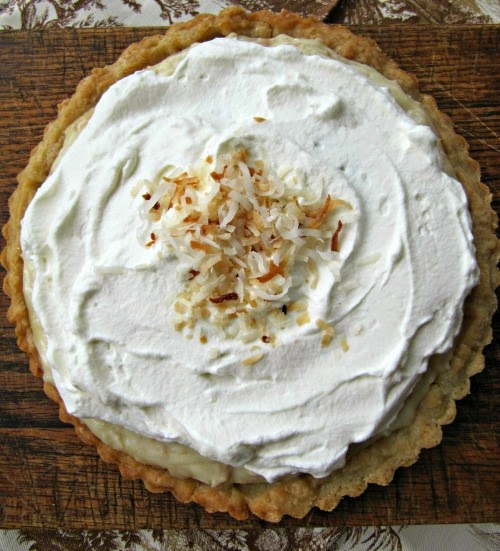 coconut cream pie with whipped cream topped with toasted coconut.