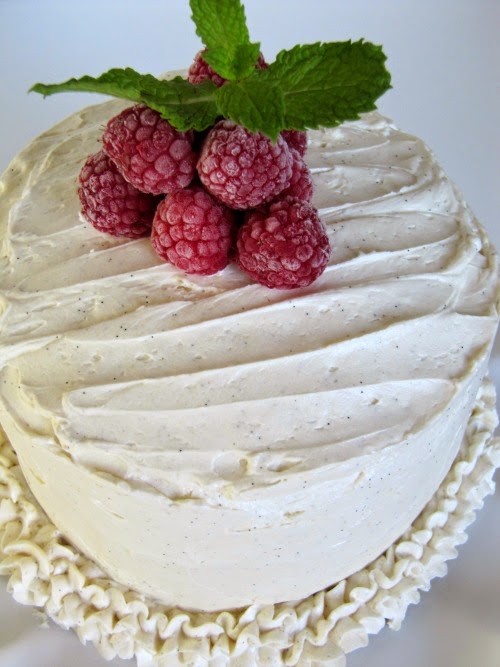 Raspberry Filled White Almond Cake Frosted with Whipped Vanilla Bean Butter Cream