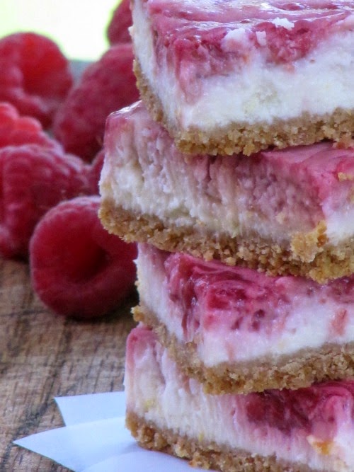 Closeup of a stack of Easy Lemon Raspberry Swirled Cheesecake Bars Recipe.