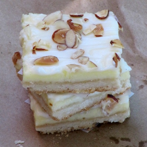 almond-cheesecake-bars on a stack. 