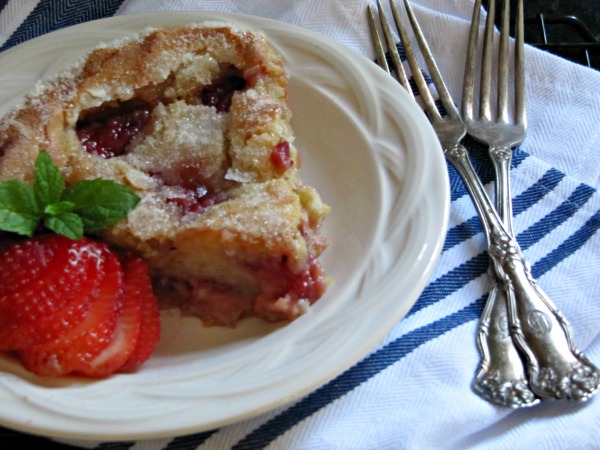 Fresh Strawberry Cake on a white plate with 2 forks.