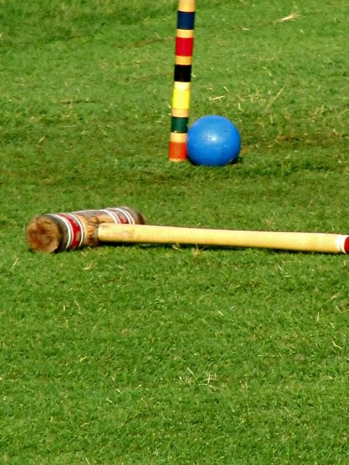 croquet mallet and blue ball with wicket. 