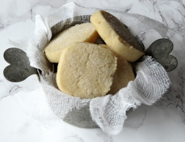 Lemon slice and bake cookies in a tin bowl with heart handles.
