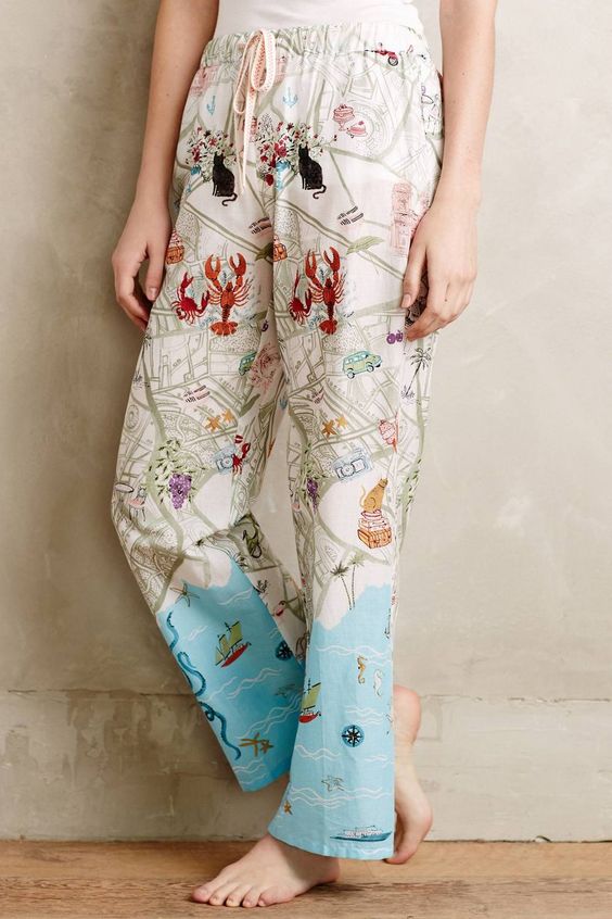 woman wearing Vikki Chu illustrated pjs with lobsters. 