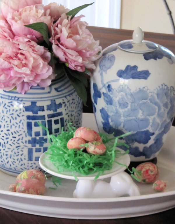 white ceramic tray with two chinoiserie vases and a cake plate with grass and Easter eggs