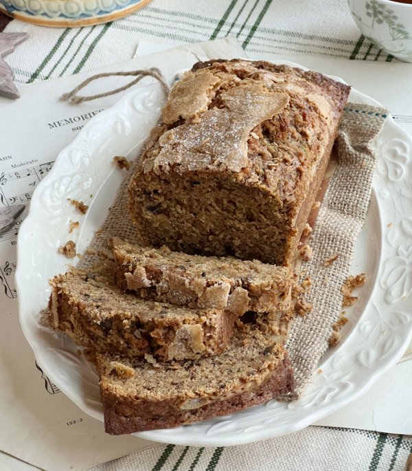 pumpkin zucchini bread sliced on a white platter.