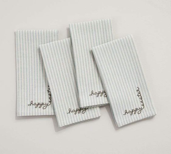 Set of four striped napkins embroidered with happy easter