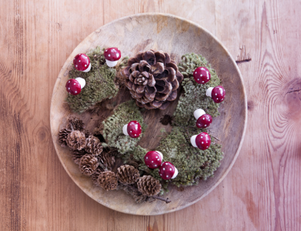pinecones in a bowl with red mushrooms