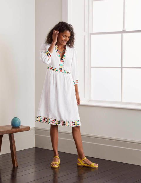 woman wearing a white embroidered dress
