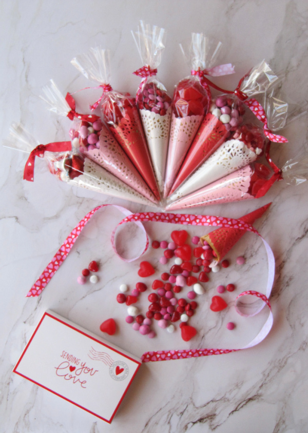 Valentine's Day treat favors made with colored doilies and ice cream cones.