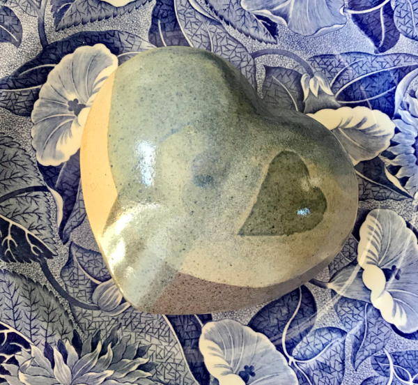 Blue pottery egg on a transfer ware plate