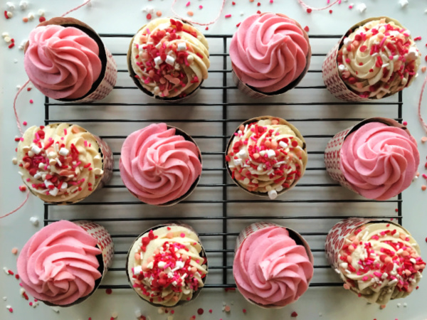chocolate-valentines day cupcakes with pink frosting others with white frosting and sprinkles