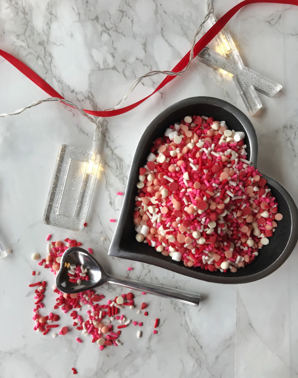 heart shaped bowl full of colorful sprinkles
