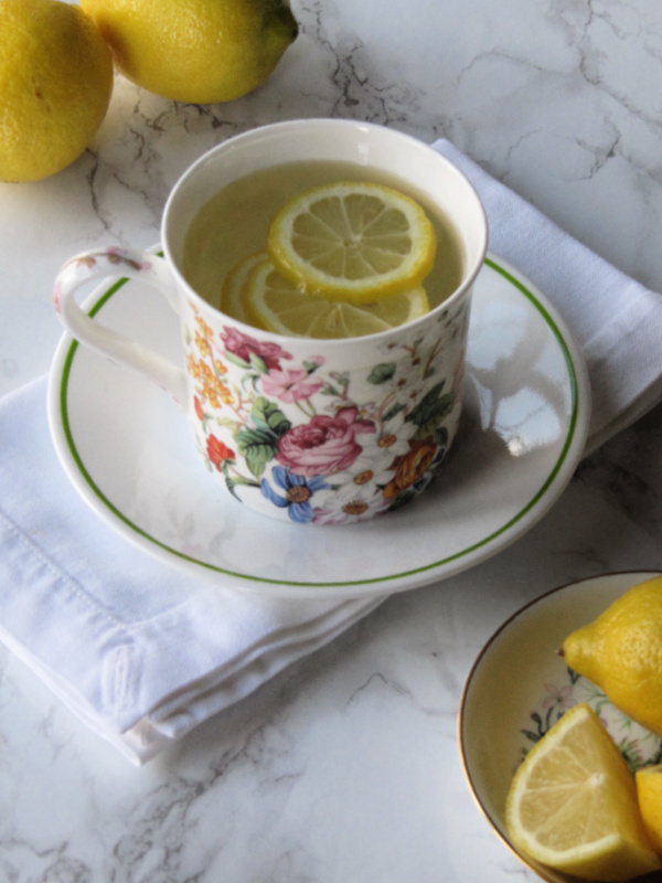 15 tips to Help you live and maintain a healthy lifestyle. Flowered cup with lemons floating in it