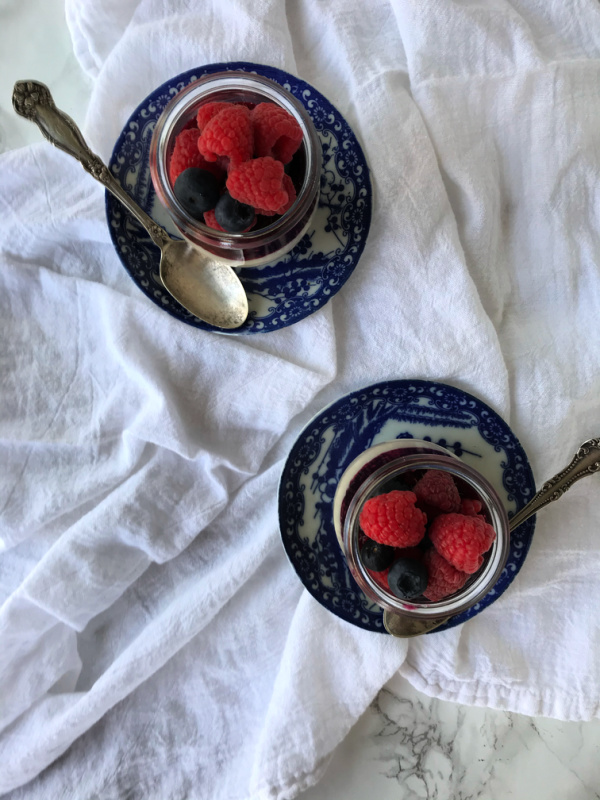 panna cotta in jars with berries on two plates