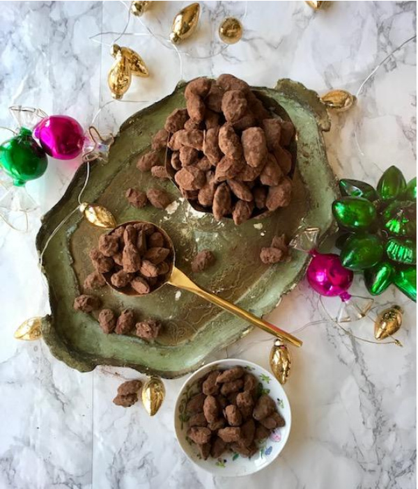 chocolate almond-dragees candy on a Florentine tray with ornaments