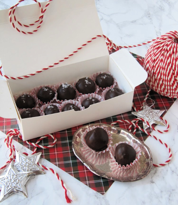 fleur-de-sel-truffles in white box sitting on a plaid square with a ball of twine next to it