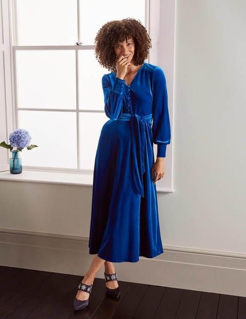 woman in a blue velvet dress