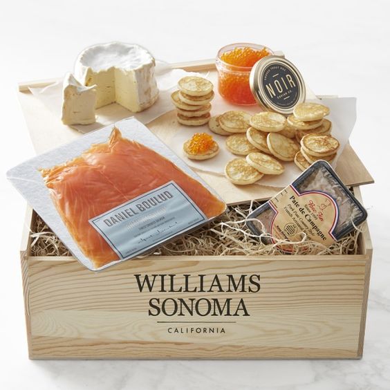 Williams Sonoma crate filled with cheese crackers salmon and other French food