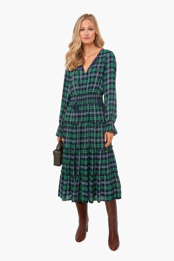 tall blond woman wearing a green and black plaid dress
