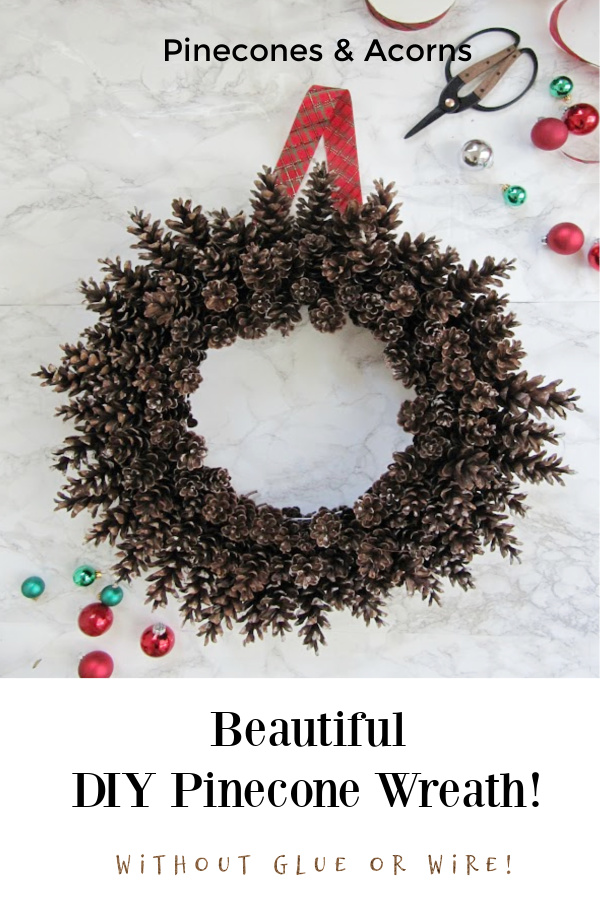 Pinecone wreath with plaid ribbon hanger on a marble backround