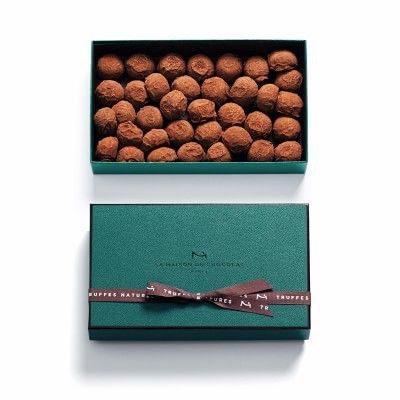 Jade colored box filled with round chocolate truffles