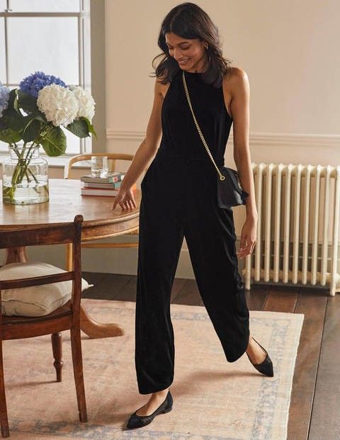 lady wearing a black Velvet jumpsuit