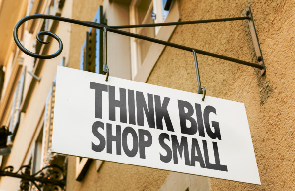 White sign that says think big shop small