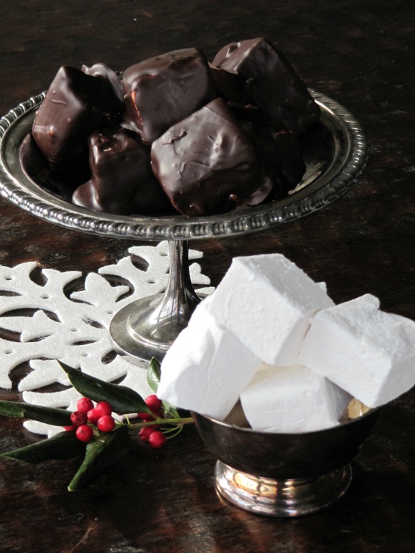 a silver footed dish with chocolate covered marshmallows and a silver dish with plain marshmallows