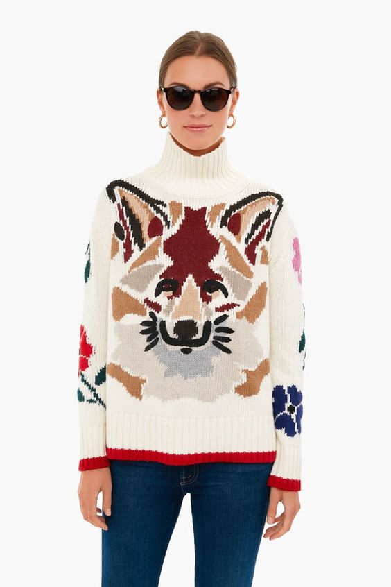 Woman wearing a sweater with a for on the front