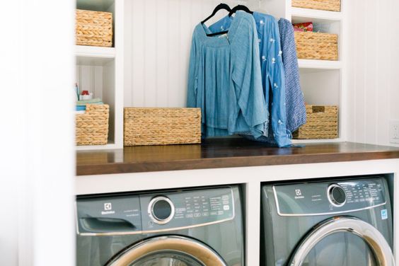 laundry room with washer and dryer and clothes hanging overhead