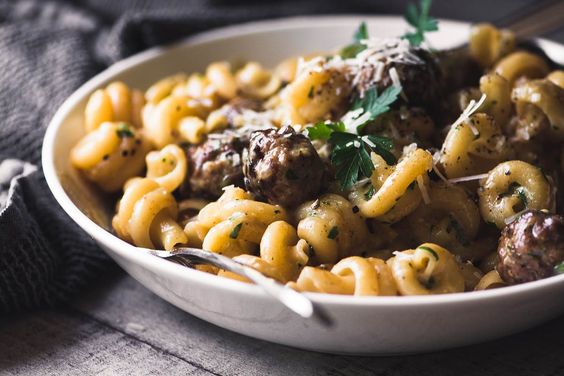 Friday favorites food white bowl filled with pasta and sausage 