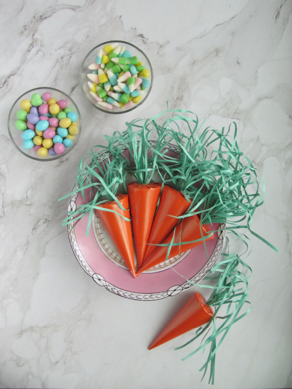 surprise easter carrot with bowls of pastel easter candy