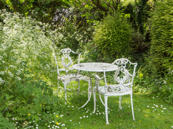 white iron chairs and table in an English garden
