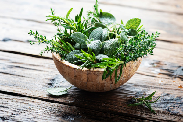 wood bowl of sage, rosemary and thyme
