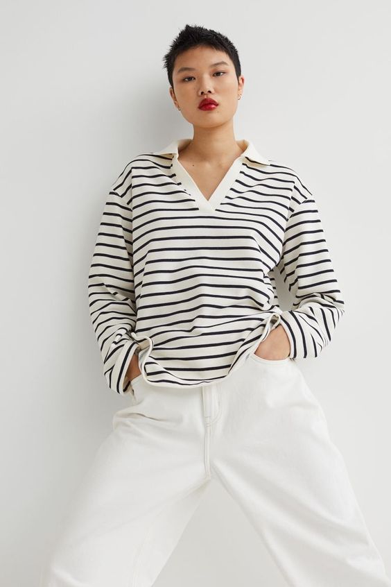 Friday Favorites find woman with short pixie cut hair wearing a blue and white striped sweatshirt and white pants