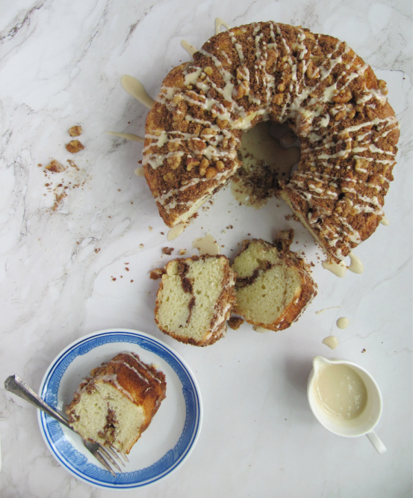 Sour cream coffee cake with a pitcher of glaze