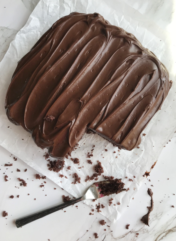 Chocolate snack cake with Hershey's chocolate frosting on parchment paper
