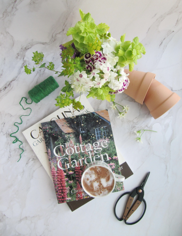Flatlay with terracotta pots garden books sizzors and twinepots garden books sizzors and twine