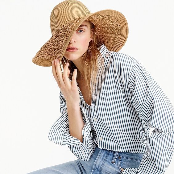 Monday musings woman in jeans blue and white striped shirt and wicker hat