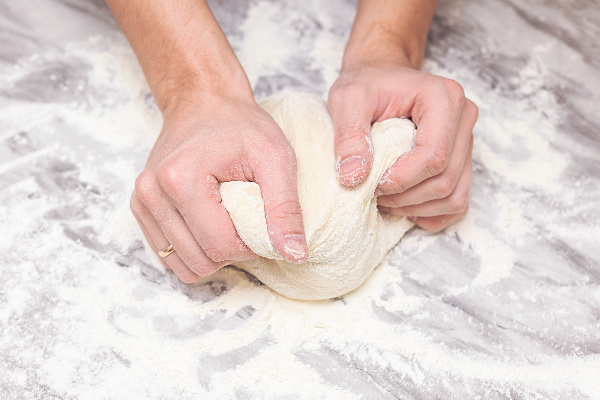 two hands kneeling bread