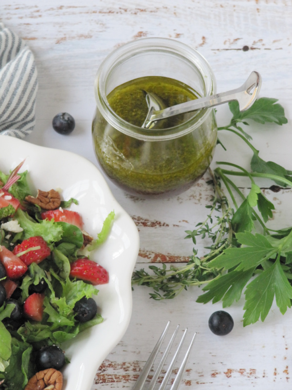 vinaigrette dressing in a glass jar with a spoon