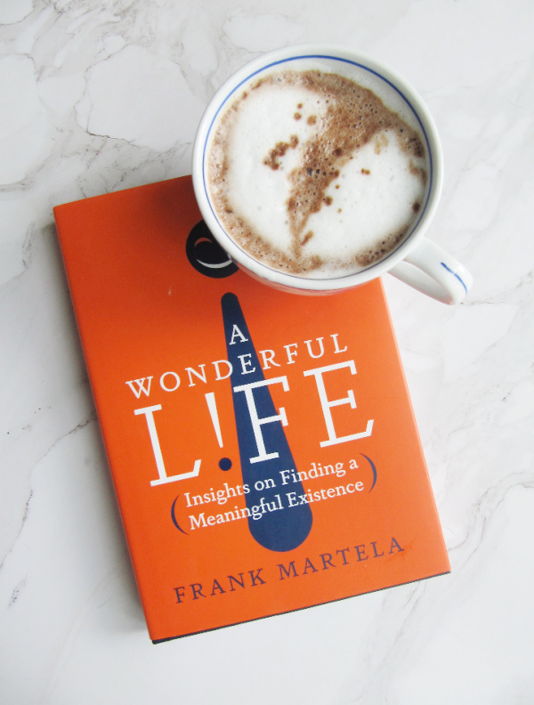 flatlay of hot chocolate and A wonderful life book frank Martela