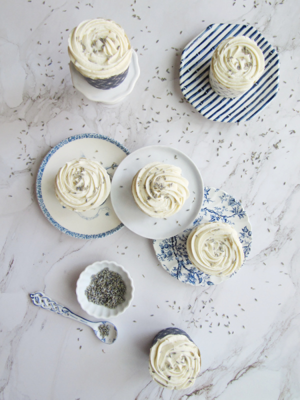 lavender cupcakes with marshmallow buttercream frosting in blue and white cupcake liners